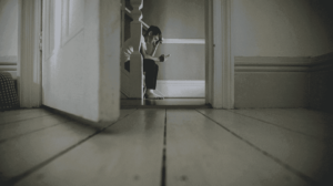 Boy on his phone looking sad