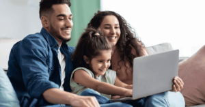 A family using a laptop together
