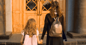 An older sister holding hands with her younger sister