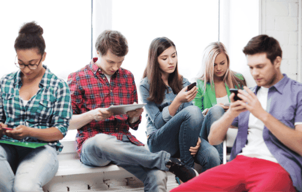 Young adults looking at their mobile devices