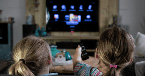 Zwei Kinder schauen einen Smart-TV.