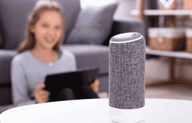 girl on device controlling a smart speaker