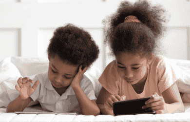 Two little kids on their devices