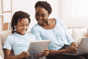 Mother and child happy on devices