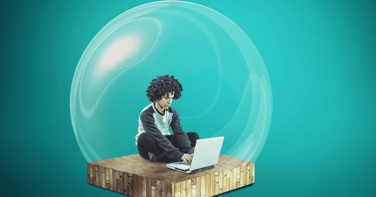 A boy uses his laptop with a bubble surrounding him to represent how echo chambers separate users from others views.