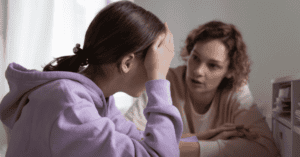 An upset girl talking with her mother
