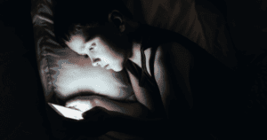 A child on a phone in bed