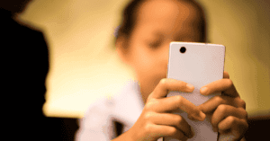 A child playing on a smartphone