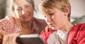 A mum and her child look at a tablet together.
