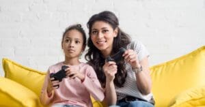 A mother and daughter playing video games together