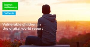 The cover of the Vulnerable Children in the Digital World report, showing a child looking out over a town.