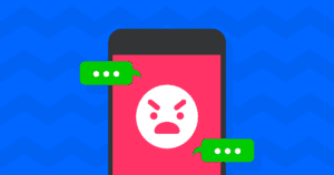 A smartphone screen showing an angry emoji face with conversation boxes around it