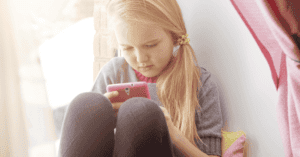 Image of a young girl on a smartphone.