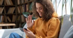 Girl on sofa using phone