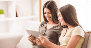 Mother and daughter on tablet together