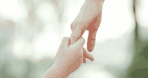 child holding adult hand