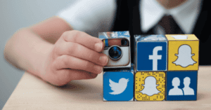 Child hold cubes that are social media platform themed