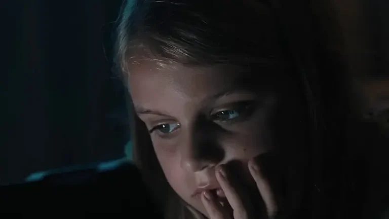 A girl with a hand on her face looking concerned. Screen time facts & advice