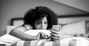 Child on phone, looking sad