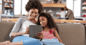 mum-and-daughter-sitting-on-the-sofa-watching-on-their-tablet