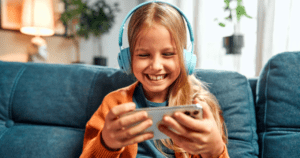 Menina olhando para o telefone com fones de ouvido