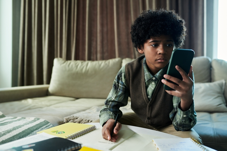A boy using his phone