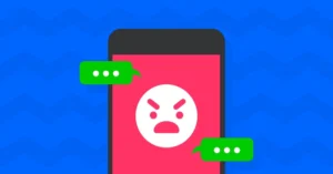 A smartphone screen showing an angry emoji face with conversation boxes around it