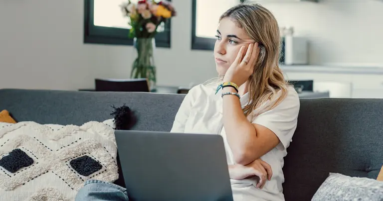A teen girl sits with a laptop, hand on her cheek as she looks off into the distance. It's the same as the report cover.
