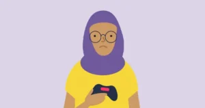 Un préadolescent tient une manette de jeu vidéo tout en ayant l'air triste.