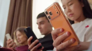 A group of teens on their phones