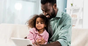 Father on device with child